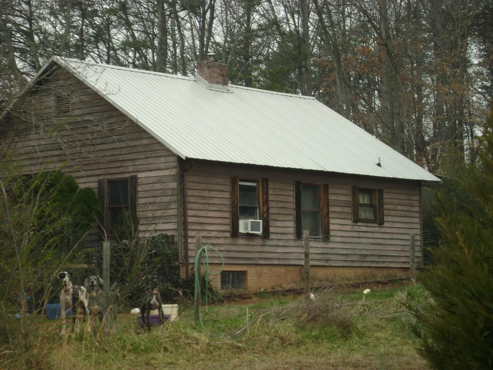 White metal roof on an old wood sided farmhouse, from a Metal Roof Installation job in Salinas